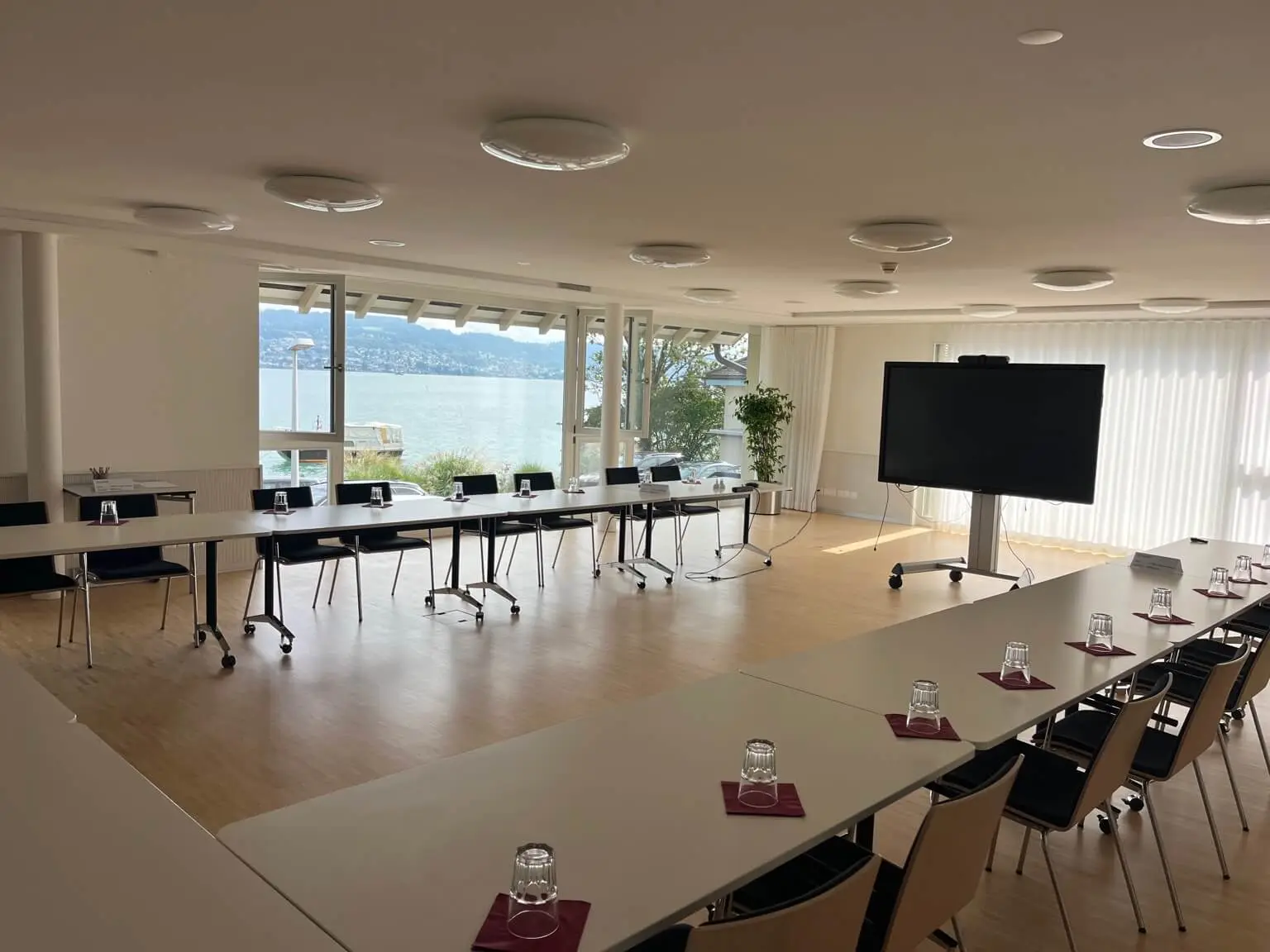 Event room set for a group with windows facing the lake