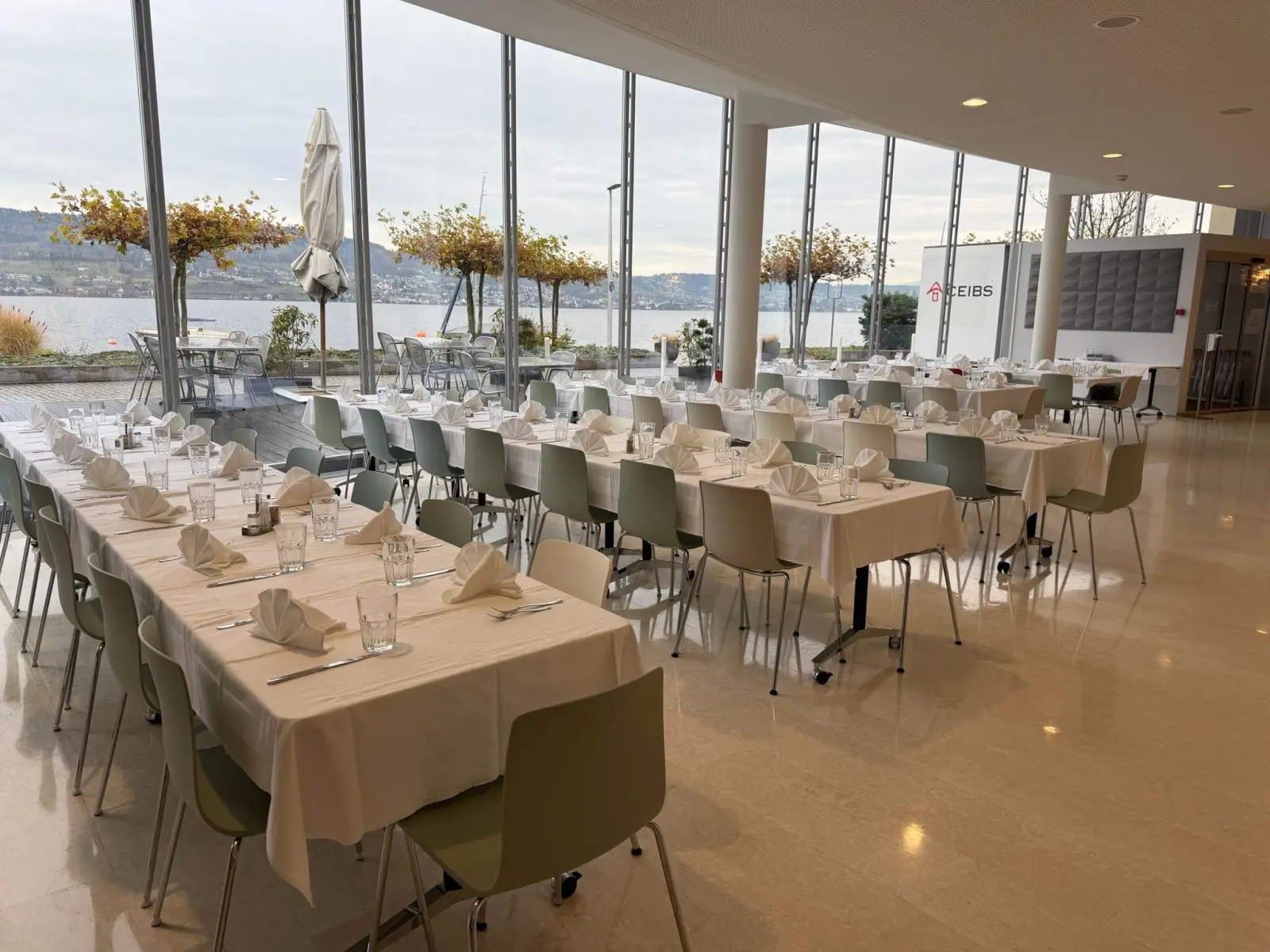 Bright dining room with floor-to-ceiling windows facing Lake Zurich