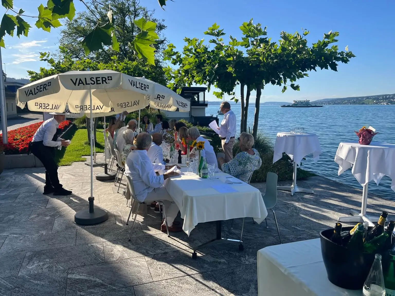Guests dining under parasols on the LAGO terrace directly on Lake Zurich in Horgen